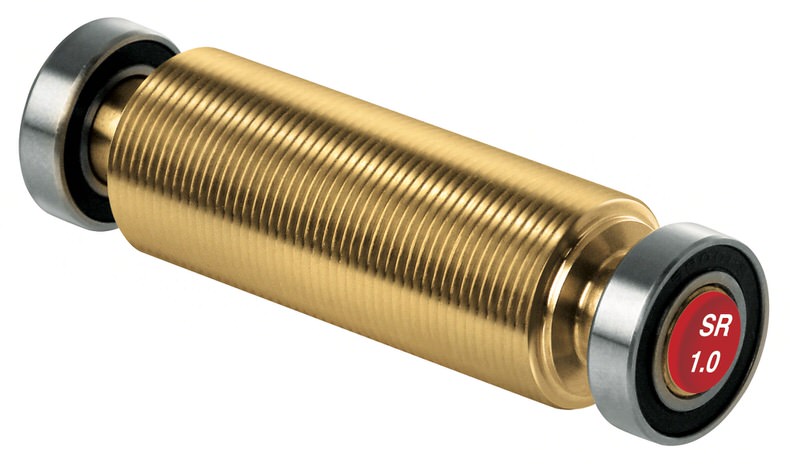 Rouleau structuré doré SR 1.0 Rouleau structuré doré avec rainures et paliers latéraux pour skis, dont un avec impression rouge "SR 1.0".