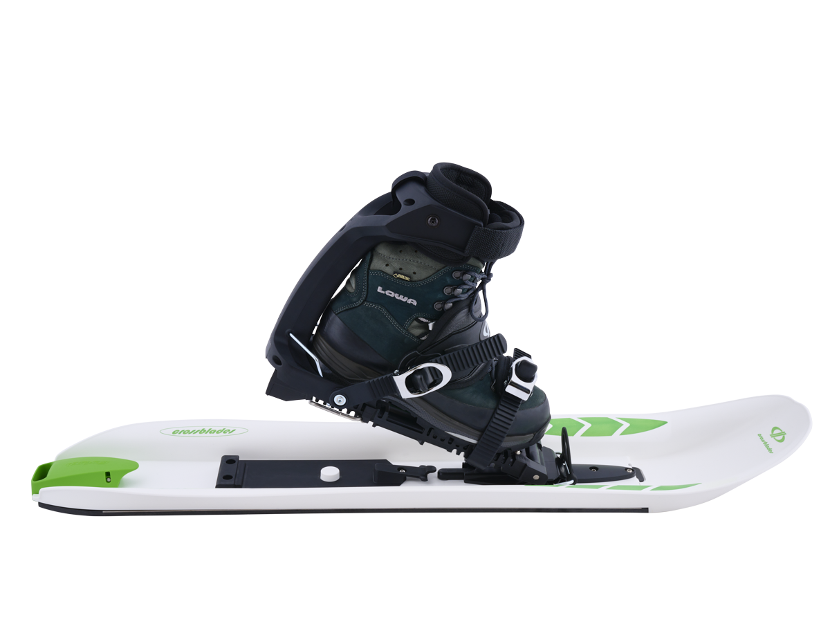 Weißer Schneeschuh mit Softboot Crossblades Softboot: Weißer Schneeschuh mit grünem Akzent und Softboot-Bindung mit Schuh.
