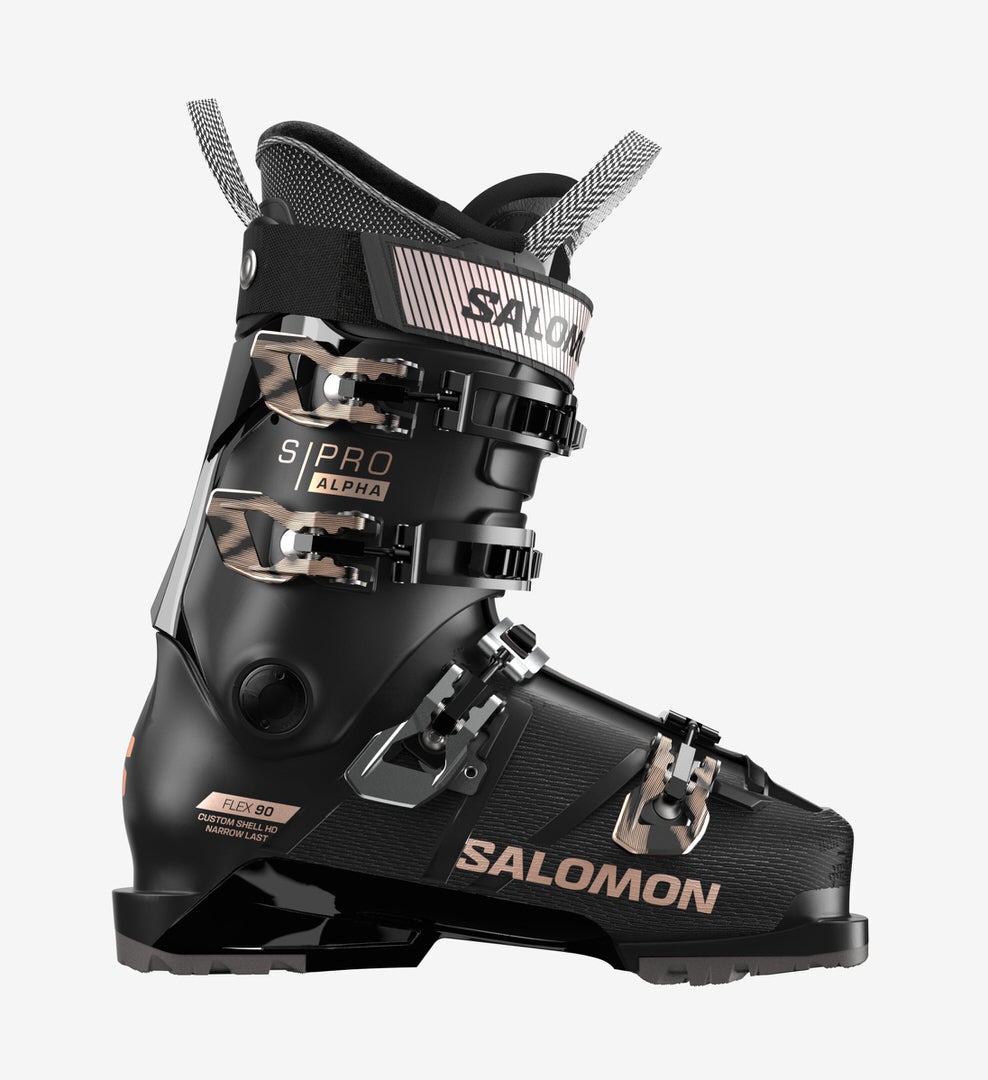 Schwarzer Salomon S/PRO ALPHA 90 W Skischuh von der Seite, mit Schnallen und Textdetails in Rosa-Gold.