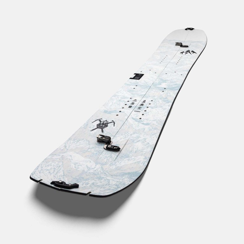 Geteiltes Jones Splitboard Ein geteiltes Jones Solution Splitboard mit Bergmuster und schwarzen Beschlägen liegt diagonal im Raum.