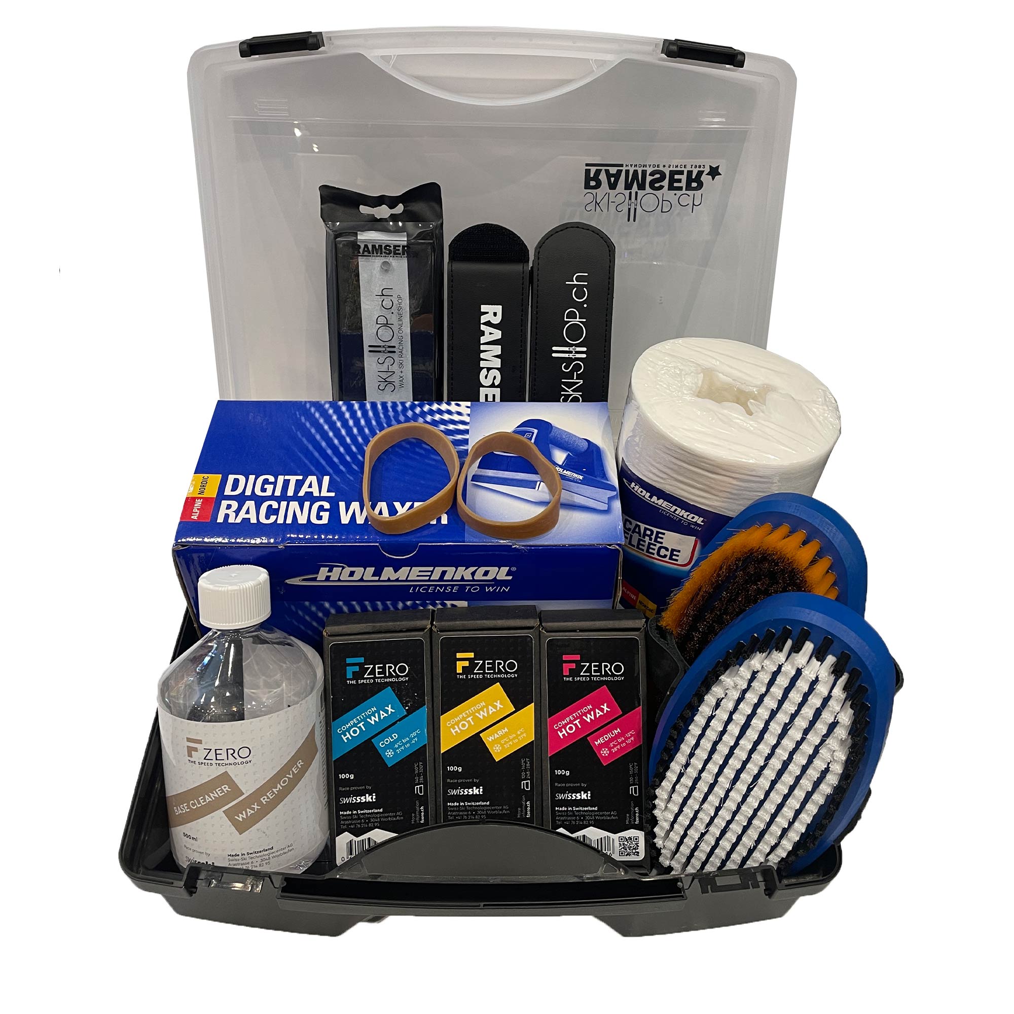 WC Pro Wax Box Inhalt: F-Zero Wachse, Reiniger, Holmenkol Bügeleisen, Bürsten, Ramser Werkzeuge in transparenter Kunststoffbox.