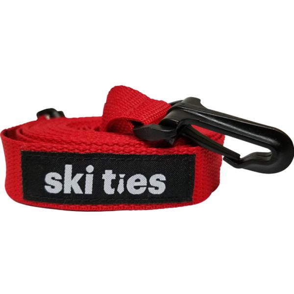 Aufgerollte, rote Ski Ties Kinder-Skileine mit schwarzem Karabinerhaken und Logo.