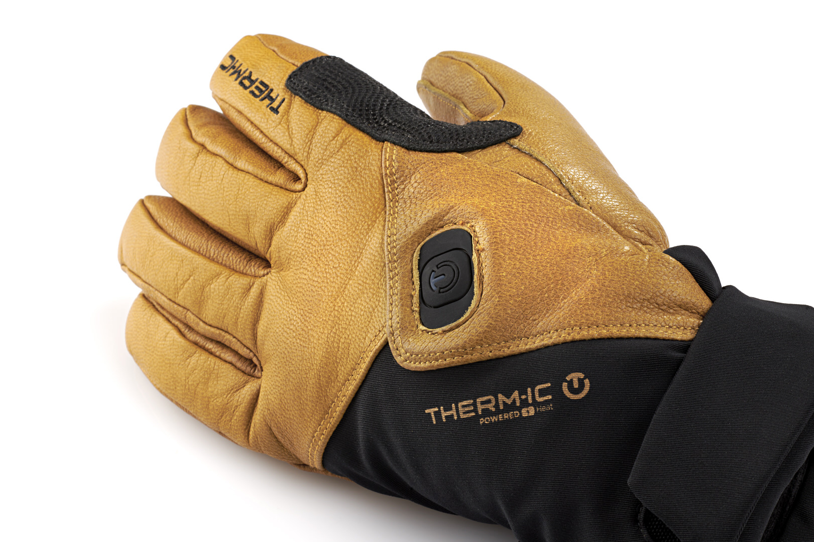 Therm-ic Freeride Handschuh Nahaufnahme eines braunen Therm-ic Freeride Ultra Heat Handschuhs mit schwarzem Bündchen und Heizknopf.