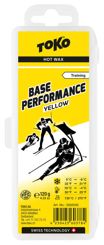 Gelber Wachsblock für Ski Gelber Wachsblock: Toko Base Performance Yellow für Ski, mit Skifahrer-Symbolen und Temperaturangaben.