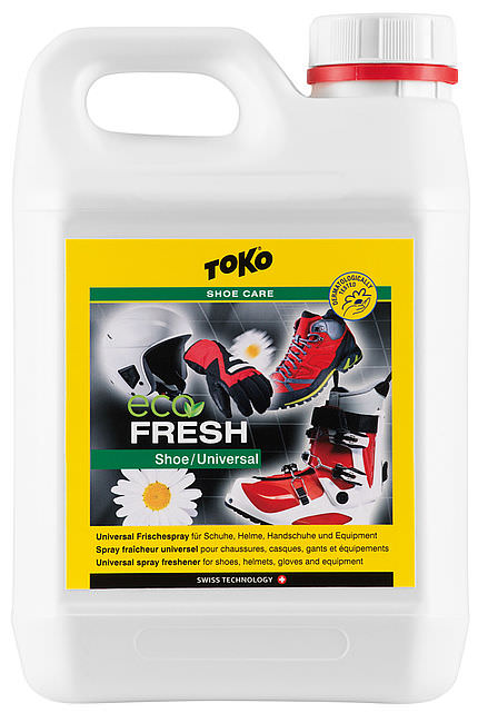 Weißer Kanister Toko Eco Shoefresh mit gelbem Etikett. Abbildung von Schuhen, Helm, Handschuhen und Bergstiefel auf dem Etikett.